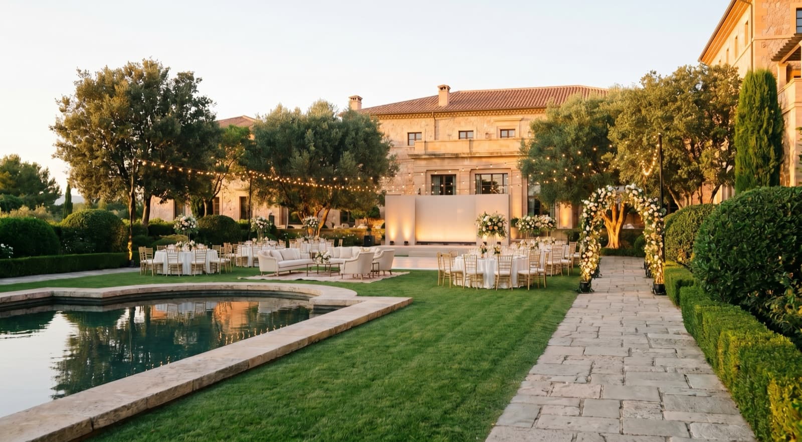 AI-rendered corporate gala setup in the same garden — stage, round tables, lighting